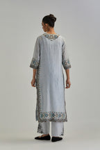 Blue slim fit straight kurta set, decorated with bold appliqué borders all along the side seam, hem and sleeve cuffs.