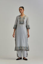Blue slim fit straight kurta set, decorated with bold appliqué borders all along the side seam, hem and sleeve cuffs.