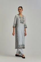 Blue slim fit straight kurta set, decorated with bold appliqué borders all along the side seam, hem and sleeve cuffs.