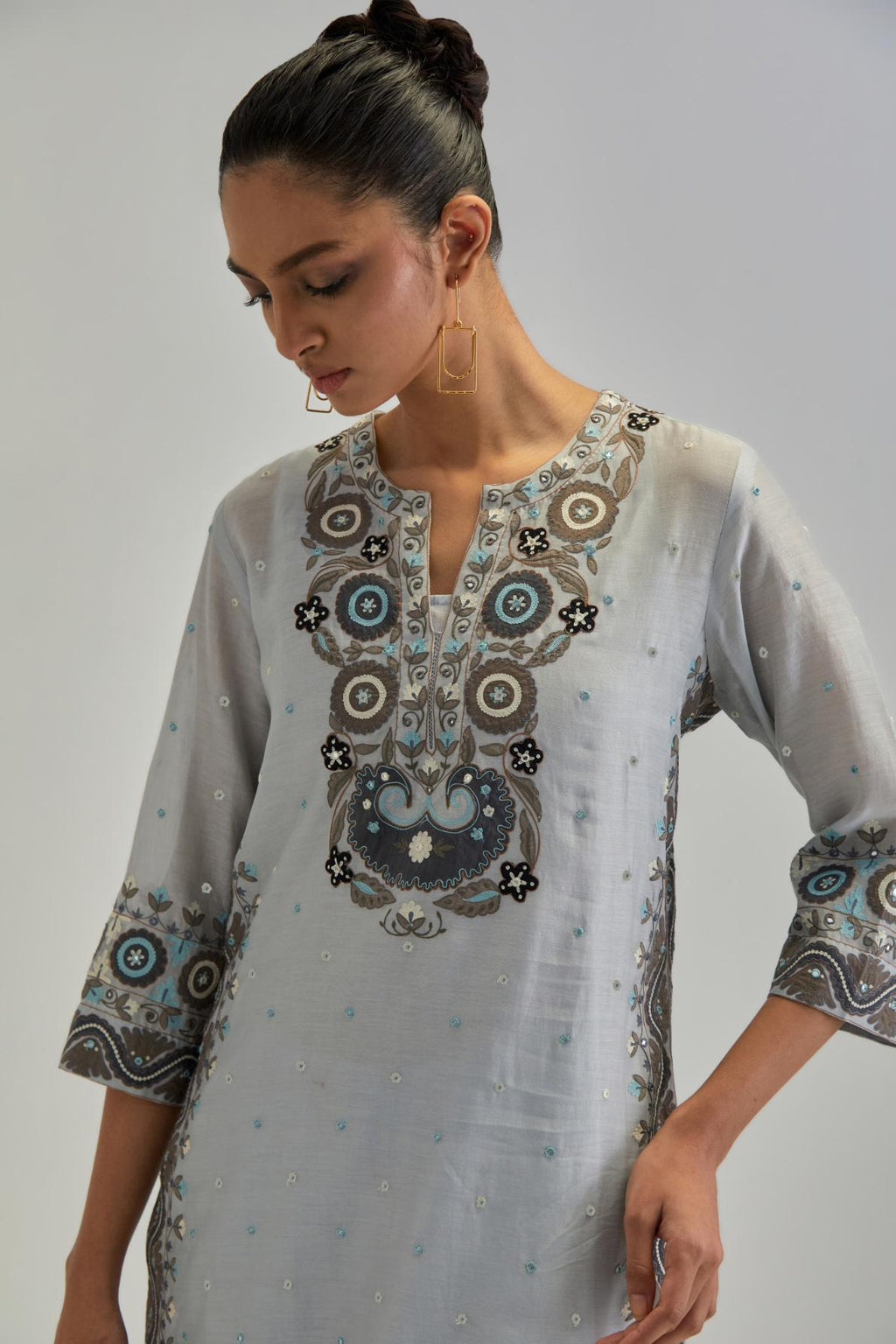 Blue slim fit straight kurta set, decorated with bold appliqué borders all along the side seam, hem and sleeve cuffs.