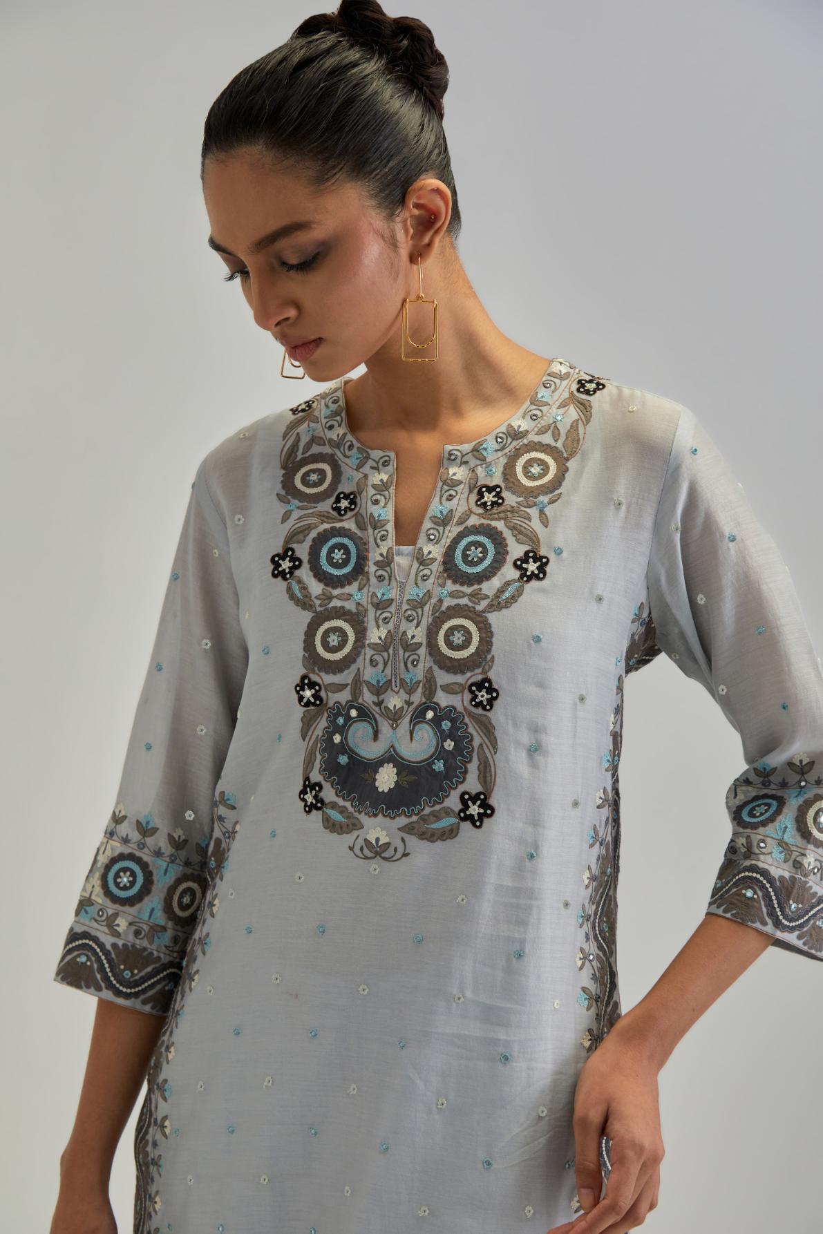 Blue slim fit straight kurta set, decorated with bold appliqué borders all along the side seam, hem and sleeve cuffs.