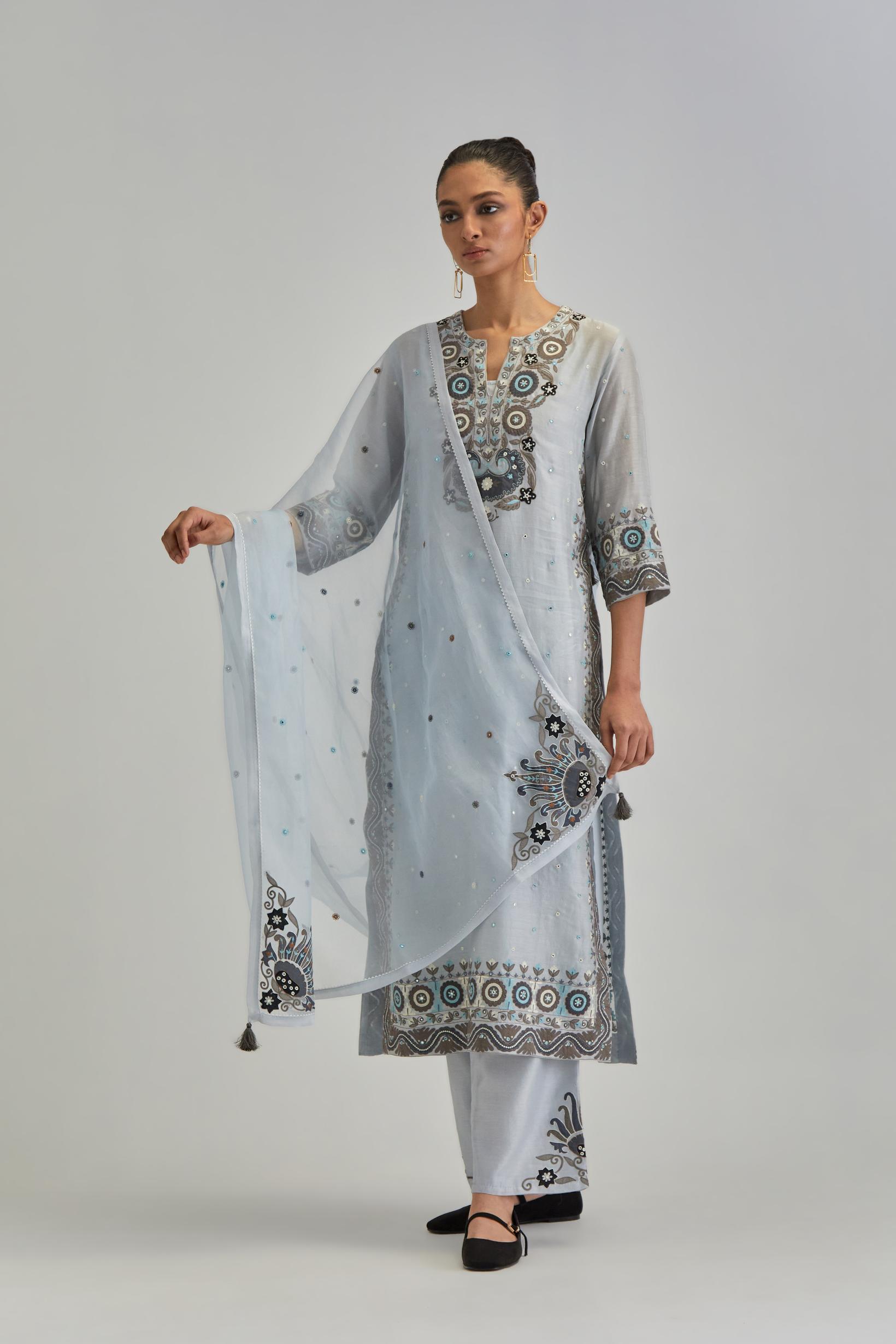 Blue slim fit straight kurta set, decorated with bold appliqué borders all along the side seam, hem and sleeve cuffs.