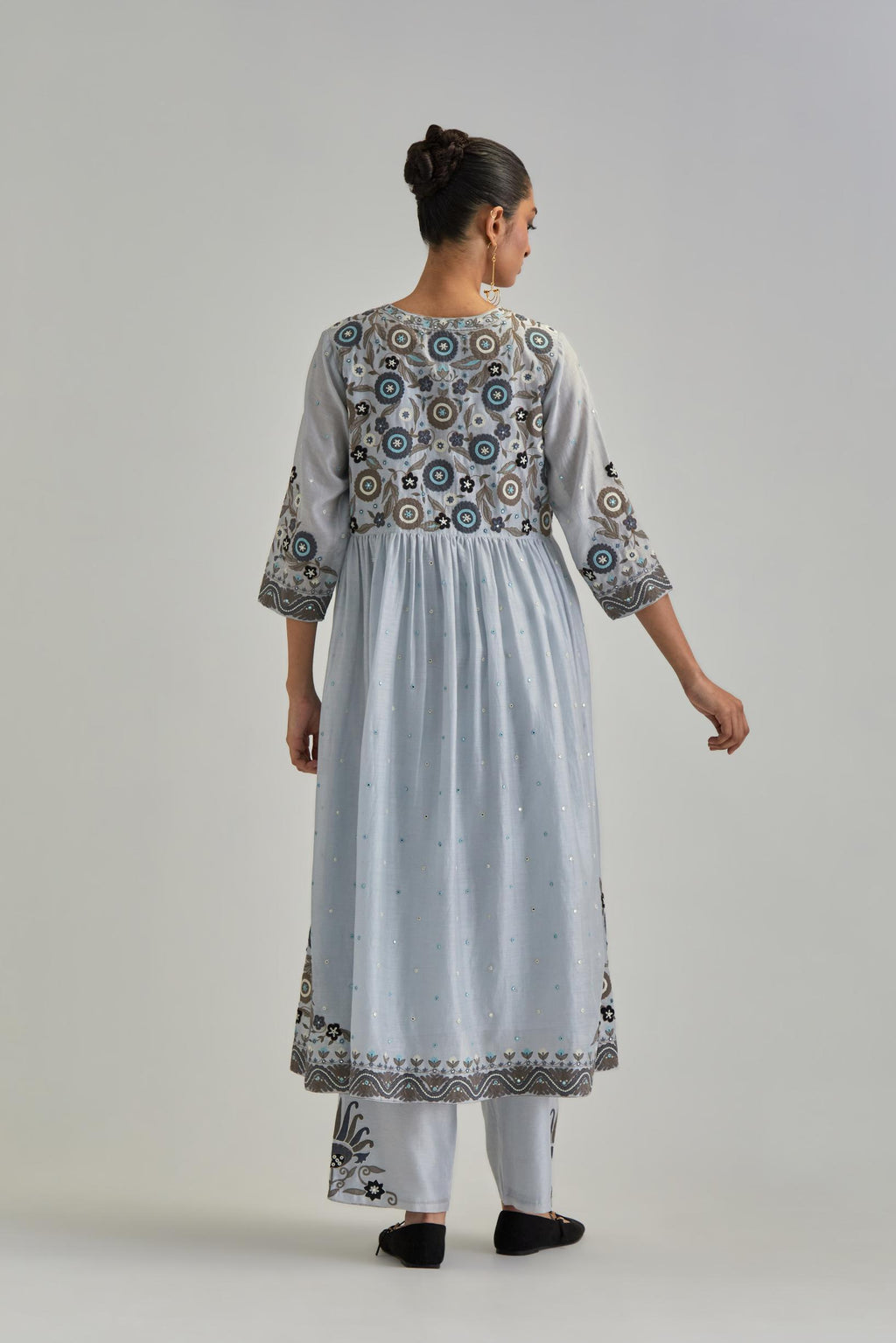 Blue silk Chanderi kurta-dress set with a wavy high-waist and fine gathers. The yoke is fully embroidered with earthy coloured circular appliqué and Aari thread work.