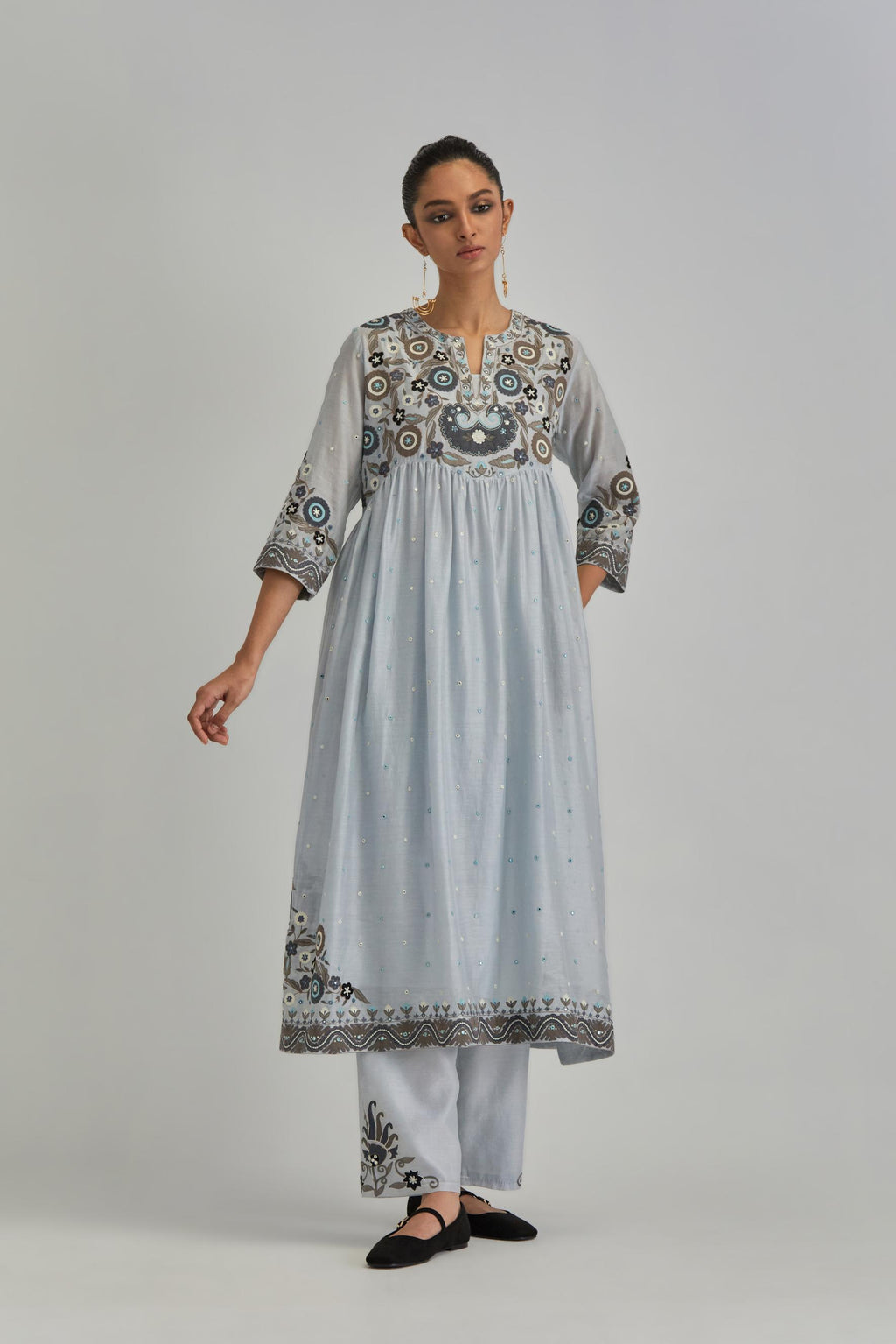Blue silk Chanderi kurta-dress set with a wavy high-waist and fine gathers. The yoke is fully embroidered with earthy coloured circular appliqué and Aari thread work.