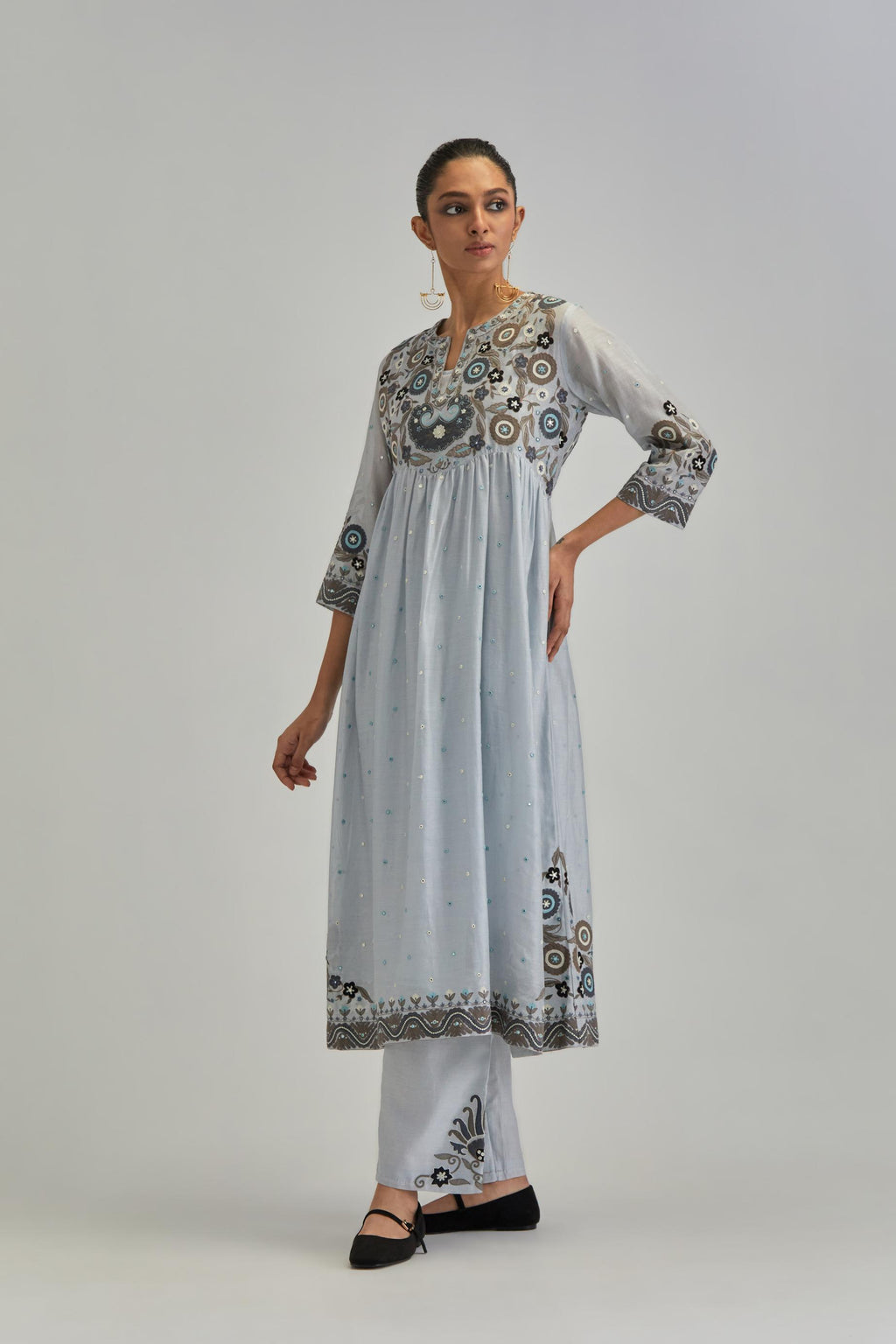 Blue silk Chanderi kurta-dress set with a wavy high-waist and fine gathers. The yoke is fully embroidered with earthy coloured circular appliqué and Aari thread work.