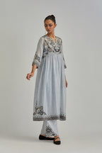 Blue silk Chanderi kurta-dress set with a wavy high-waist and fine gathers. The yoke is fully embroidered with earthy coloured circular appliqué and Aari thread work.