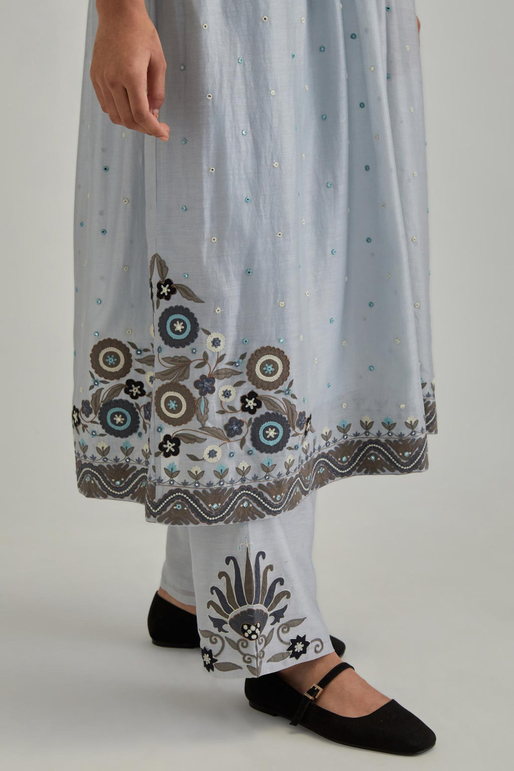 Blue silk Chanderi kurta-dress set with a wavy high-waist and fine gathers. The yoke is fully embroidered with earthy coloured circular appliqué and Aari thread work.