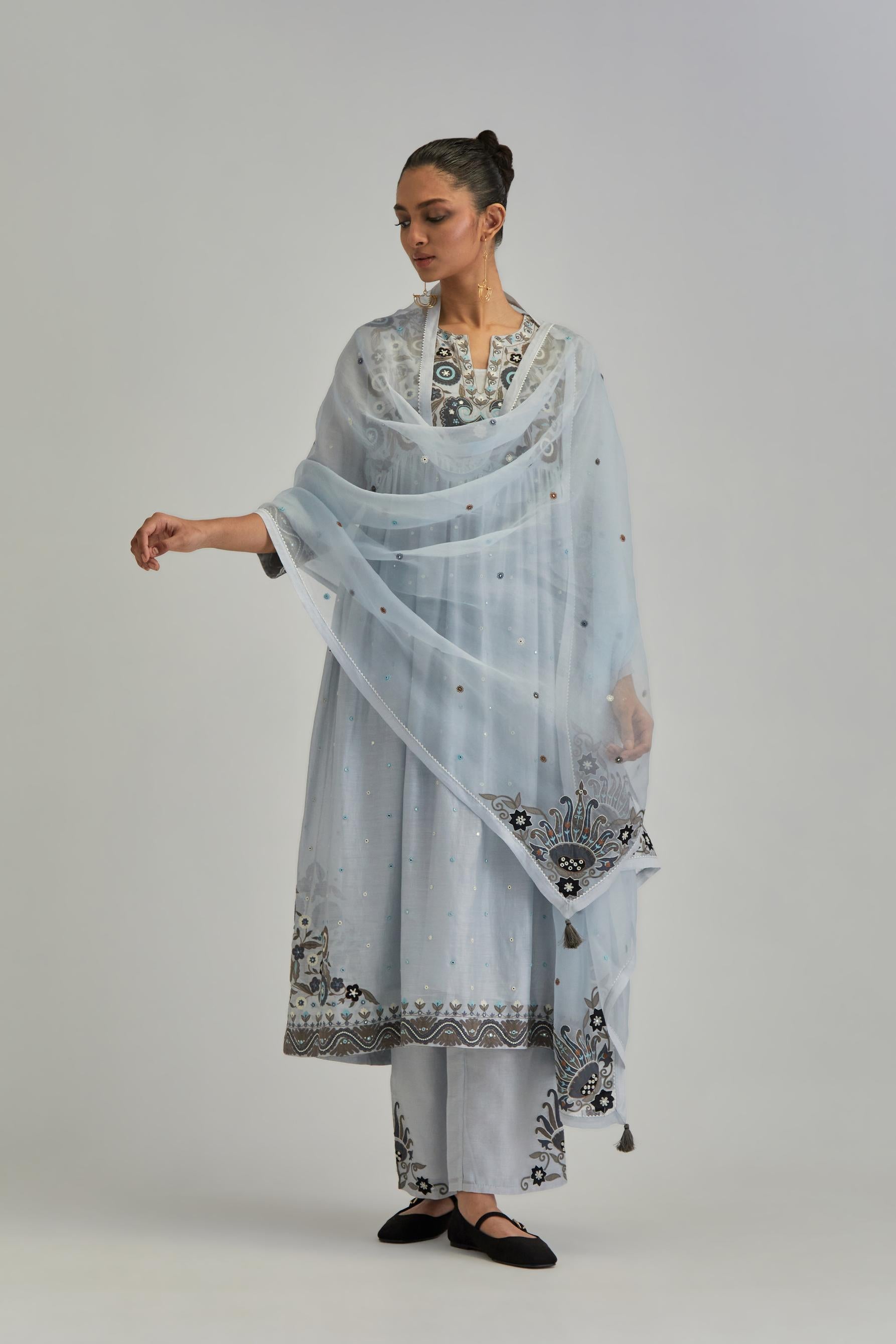 Blue silk Chanderi kurta-dress set with a wavy high-waist and fine gathers. The yoke is fully embroidered with earthy coloured circular appliqué and Aari thread work.