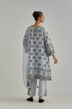 Blue silk Chanderi straight hem mid-length abha style kurta set with bold appliqué embroidery along with earthy-coloured Aari thread work and tassels.
