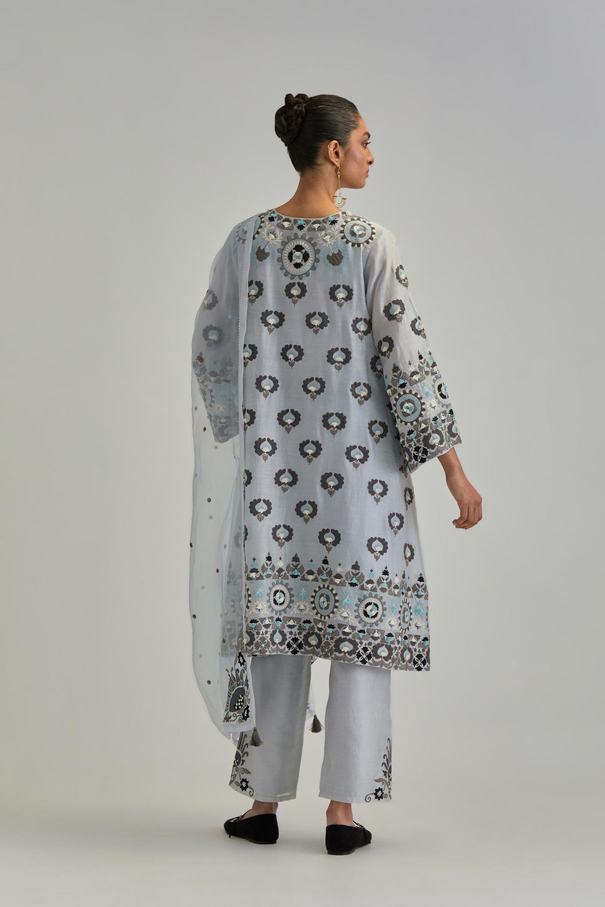 Blue silk Chanderi straight hem mid-length abha style kurta set with bold appliqué embroidery along with earthy-coloured Aari thread work and tassels.