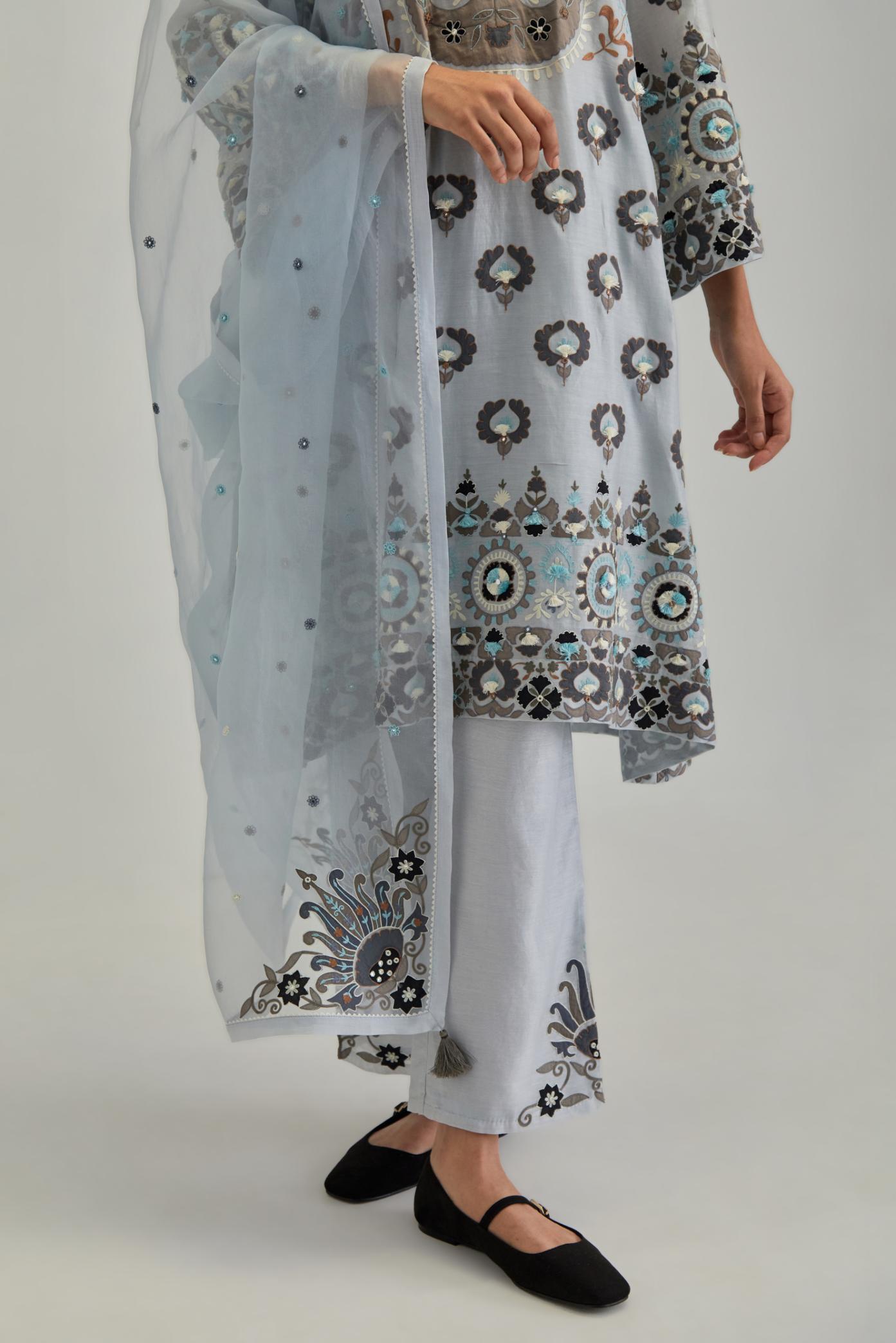 Blue silk organza dupatta with appliqué work and earthy coloured flower embroidery all-over the dupatta.