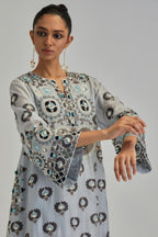 Blue silk Chanderi straight hem mid-length abha style kurta set with bold appliqué embroidery along with earthy-coloured Aari thread work and tassels.