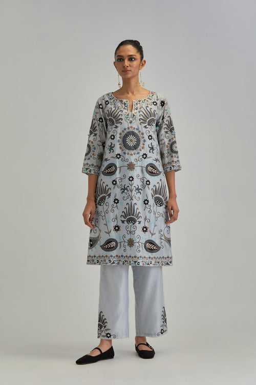 Blue short A-line silk Chanderi kurta set, fully embroidered with earthy coloured appliqué with Aari thread work and silk tassels.