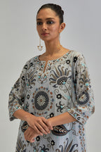Blue short A-line silk Chanderi kurta set, fully embroidered with earthy coloured appliqué with Aari thread work and silk tassels.