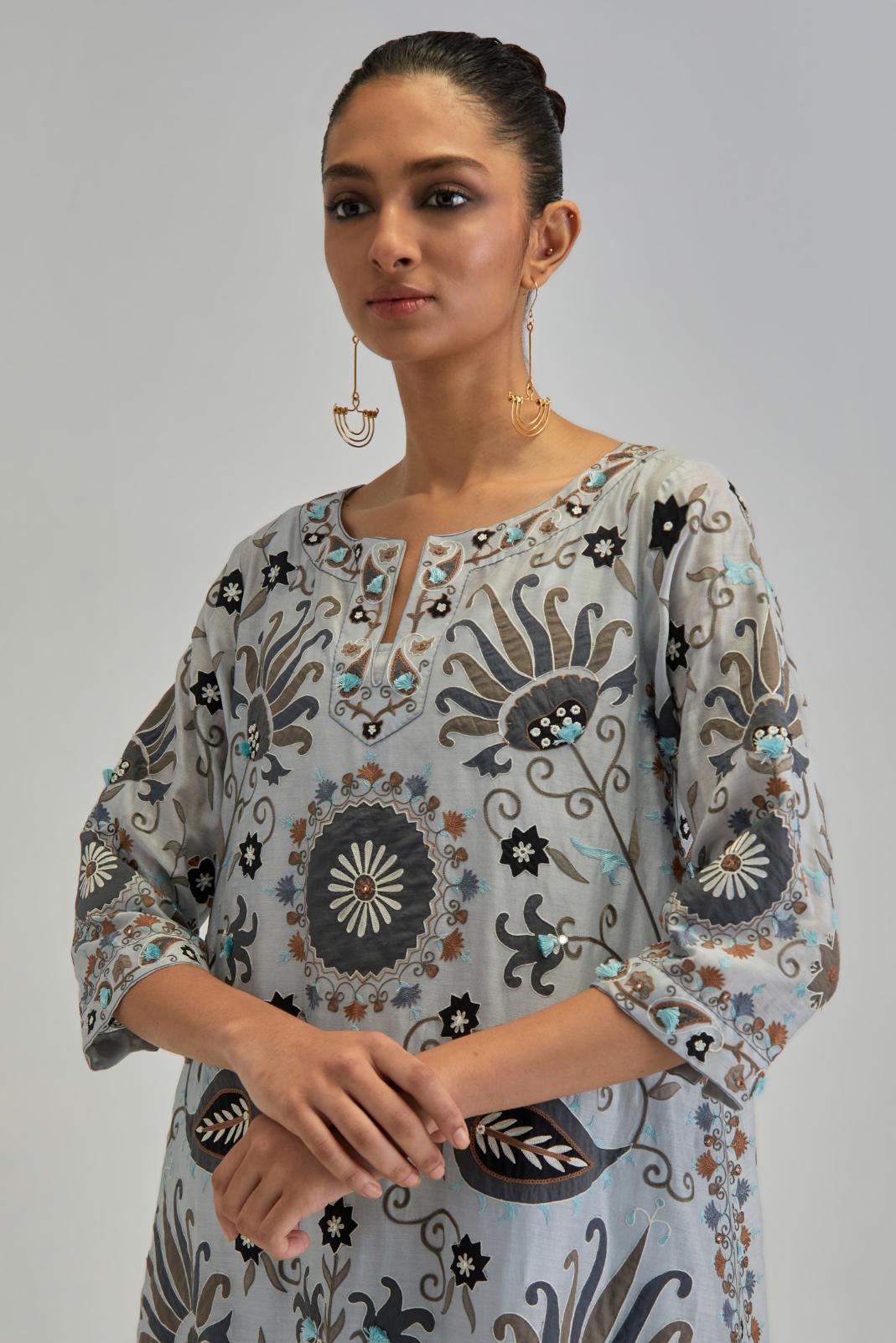Blue short A-line silk Chanderi kurta set, fully embroidered with earthy coloured appliqué with Aari thread work and silk tassels.