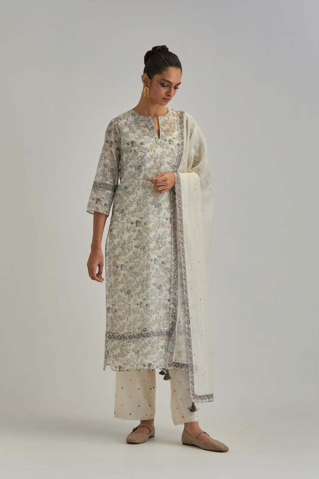 Silk Chanderi straight long kurta set with all-over earthy coloured hand block print and embroidery at kurta hem and sleeves.