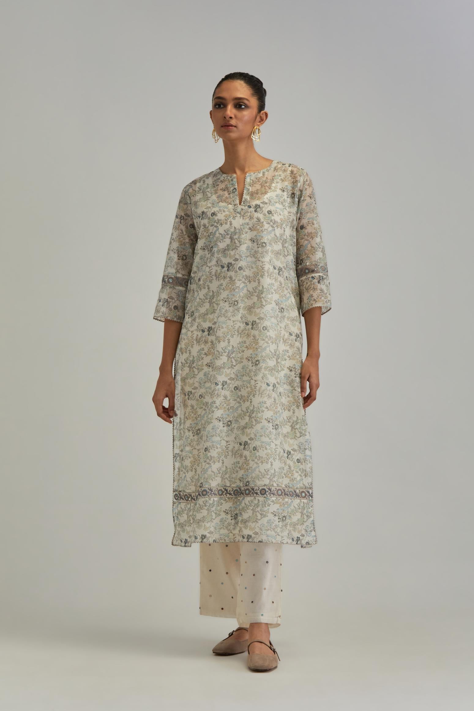 Silk Chanderi straight long kurta set with all-over earthy coloured hand block print and embroidery at kurta hem and sleeves.