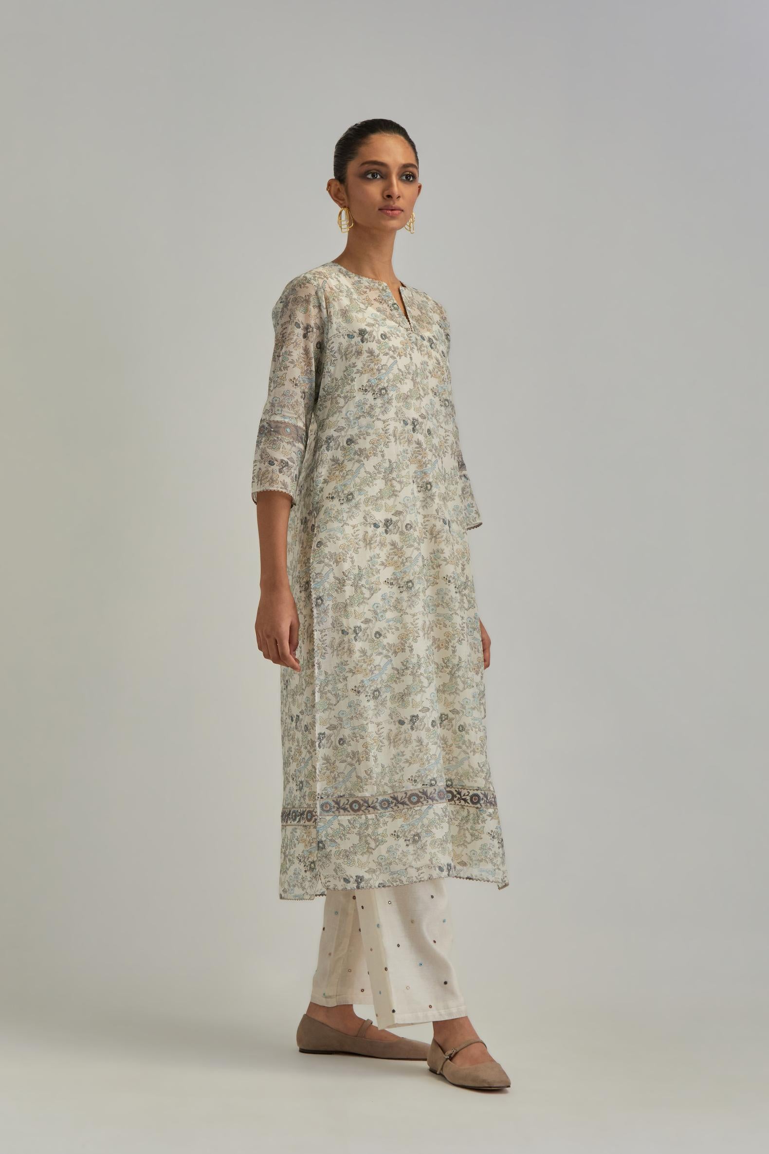 Silk Chanderi straight long kurta set with all-over earthy coloured hand block print and embroidery at kurta hem and sleeves.