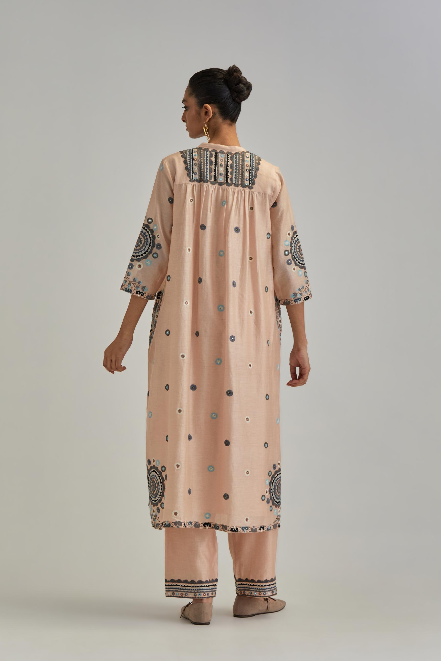 Pink silk Chanderi gathered kurta-dress set with appliqué stripes along with aari thread work flowers and floral trellises along with a circular appliqued motif.