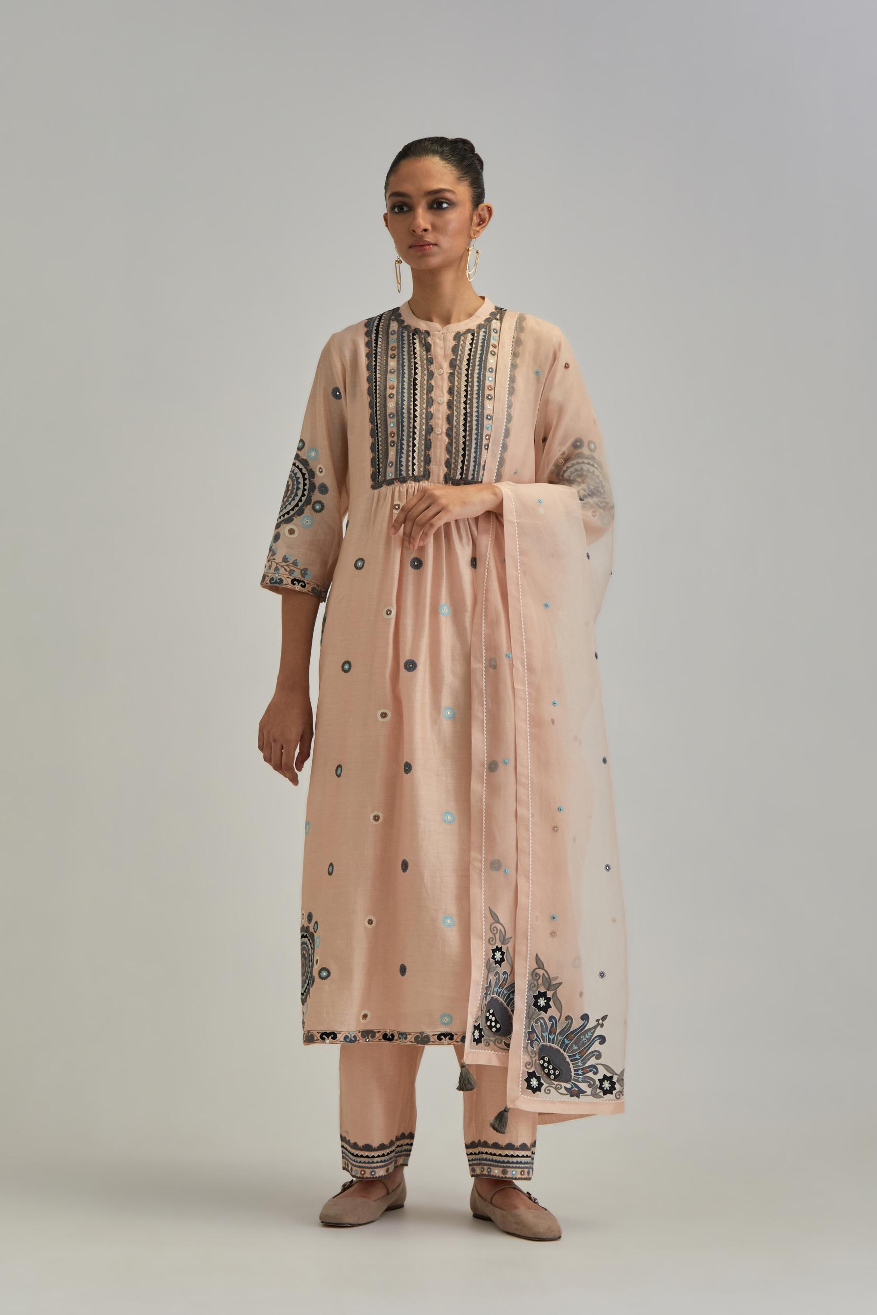 Pink silk Chanderi gathered kurta-dress set with appliqué stripes along with aari thread work flowers and floral trellises along with a circular appliqued motif.