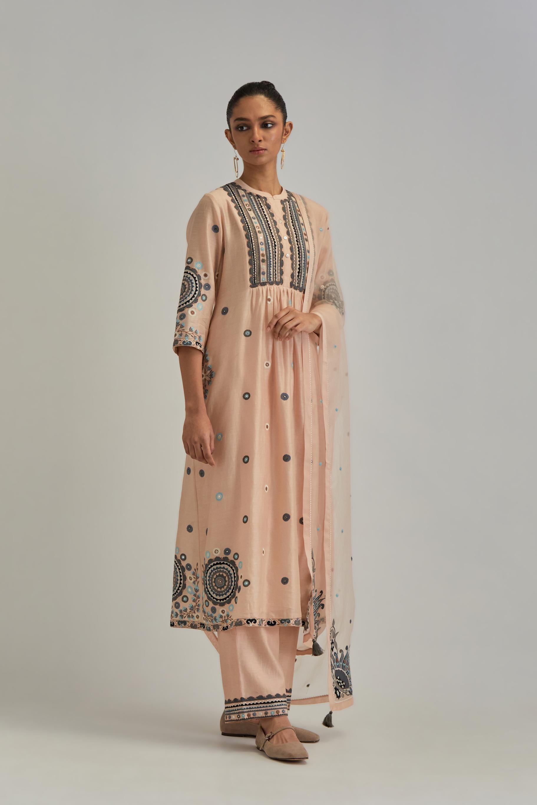 Pink silk Chanderi gathered kurta-dress set with appliqué stripes along with aari thread work flowers and floral trellises along with a circular appliqued motif.