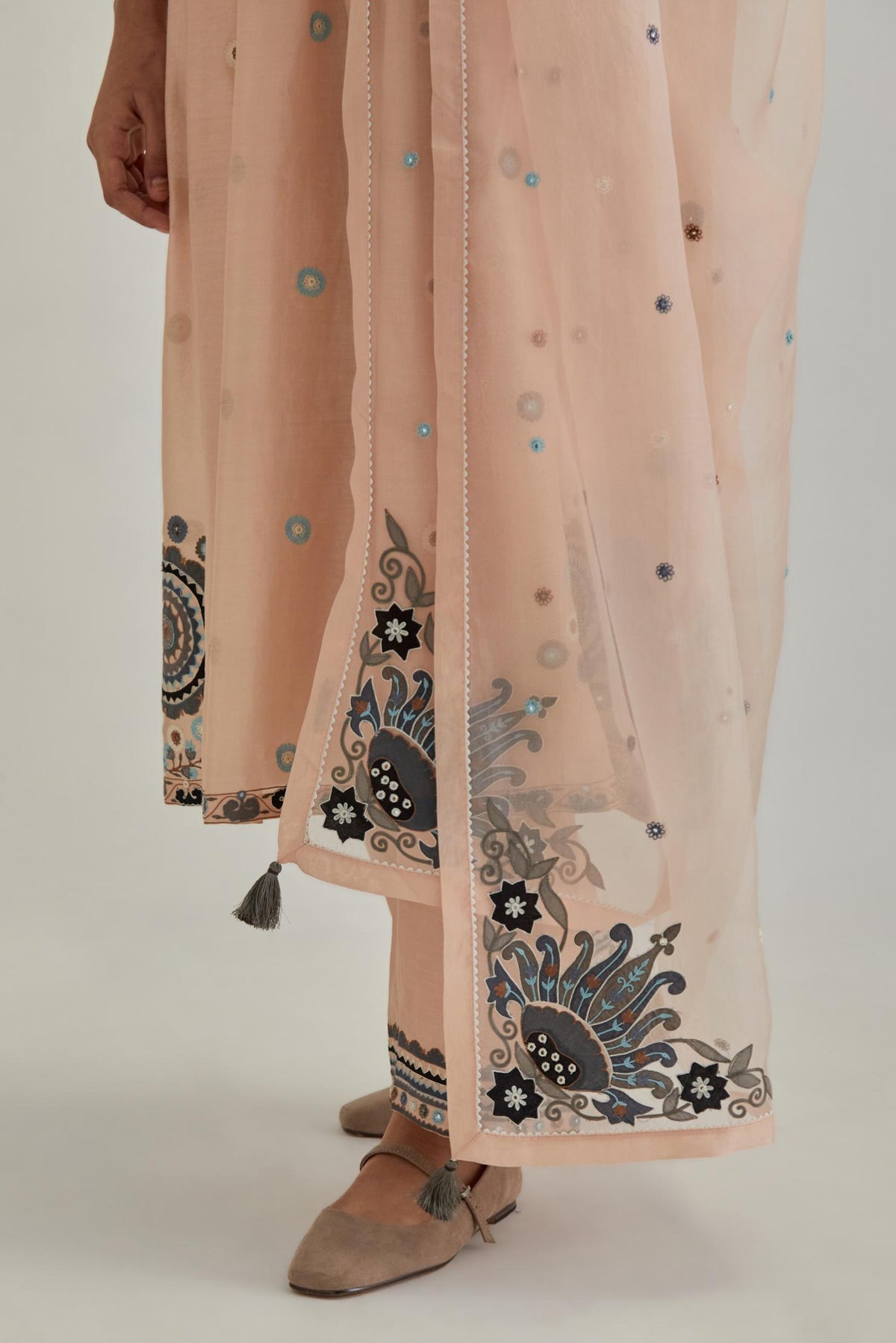Pink silk Chanderi gathered kurta-dress set with appliqué stripes along with aari thread work flowers and floral trellises along with a circular appliqued motif.