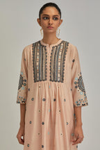 Pink silk Chanderi gathered kurta-dress set with appliqué stripes along with aari thread work flowers and floral trellises along with a circular appliqued motif.