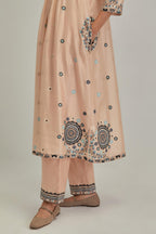 Pink silk Chanderi gathered kurta-dress set with appliqué stripes along with aari thread work flowers and floral trellises along with a circular appliqued motif.