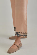 Pink silk Chanderi straight pants with earthy coloured applique and Aari thread work at hem.