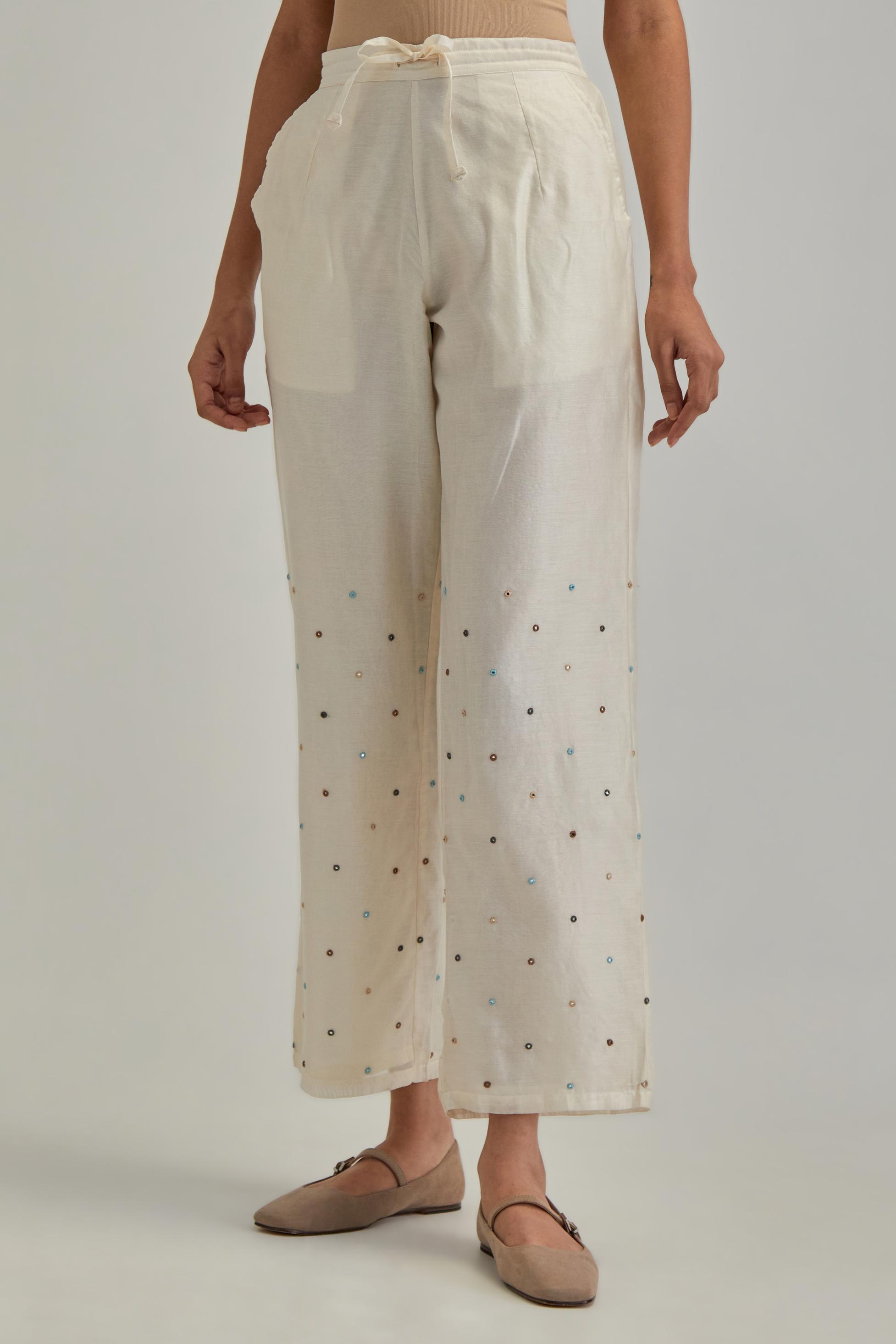 Off White silk Chanderi straight pants with mirror work, highlighted with earthy coloured thread work.