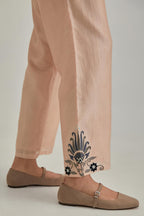 Pink silk Chanderi straight pants with earthy coloured appliqué at hem.
