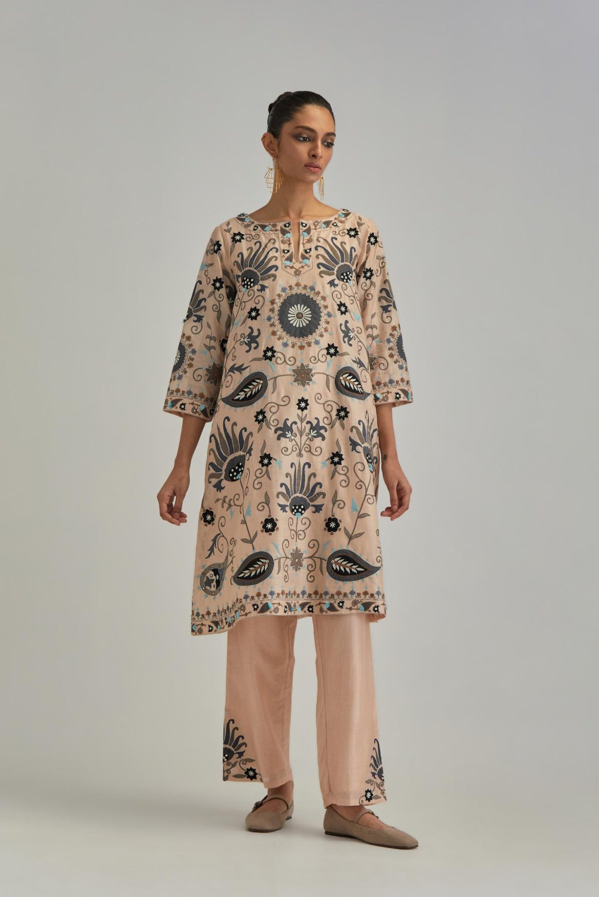 Pink short A-line silk Chanderi kurta set, fully embroidered with earthy coloured appliqué with Aari thread work and silk tassels.