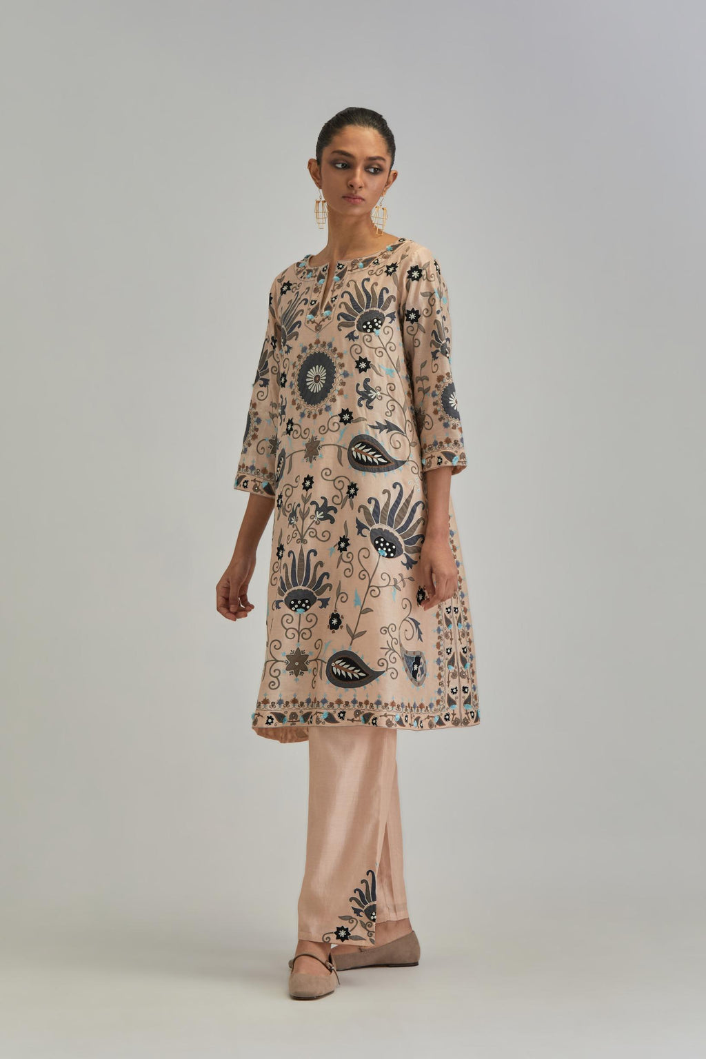 Pink short A-line silk Chanderi kurta set, fully embroidered with earthy coloured appliqué with Aari thread work and silk tassels.