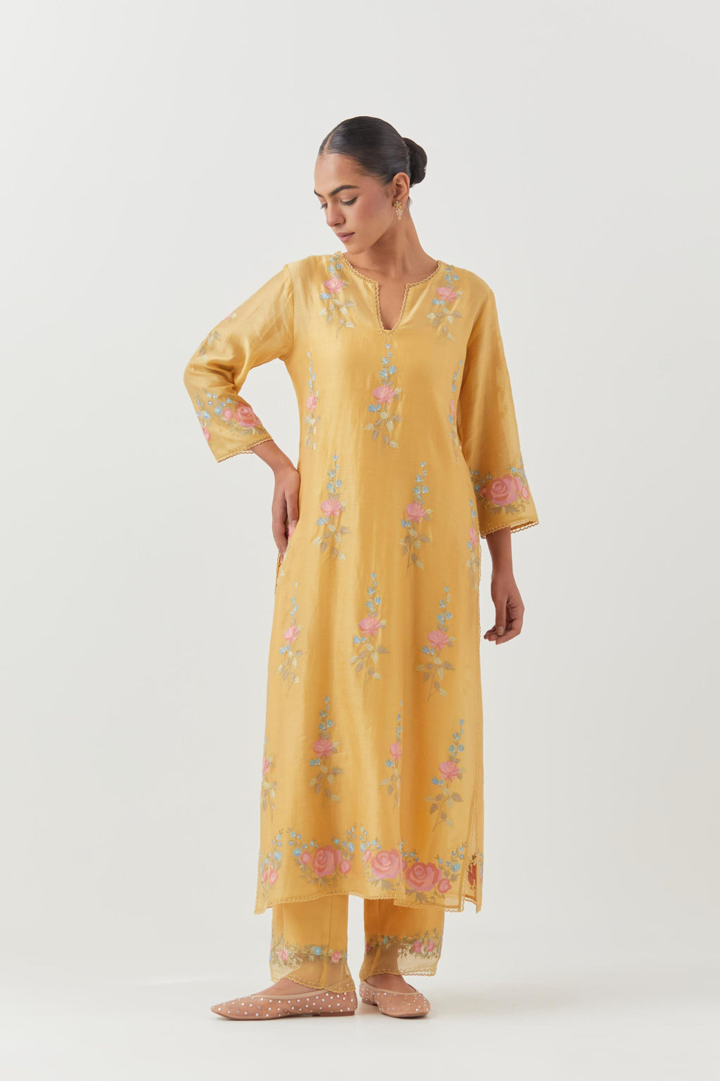 Yellow silk Chanderi straight kurta set with all-over rose embroidery and scalloped organza detail at the edges.