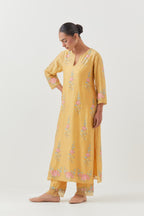 Yellow silk Chanderi straight kurta set with all-over rose embroidery and scalloped organza detail at the edges.