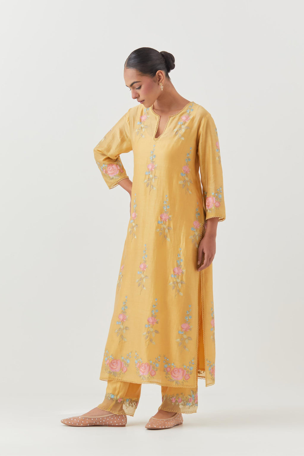 Yellow silk Chanderi straight kurta set with all-over rose embroidery and scalloped organza detail at the edges.