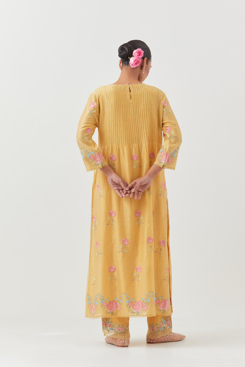 Yellow silk chanderi kurta set with pin tucks at yoke and all-over rose flower embroidery.