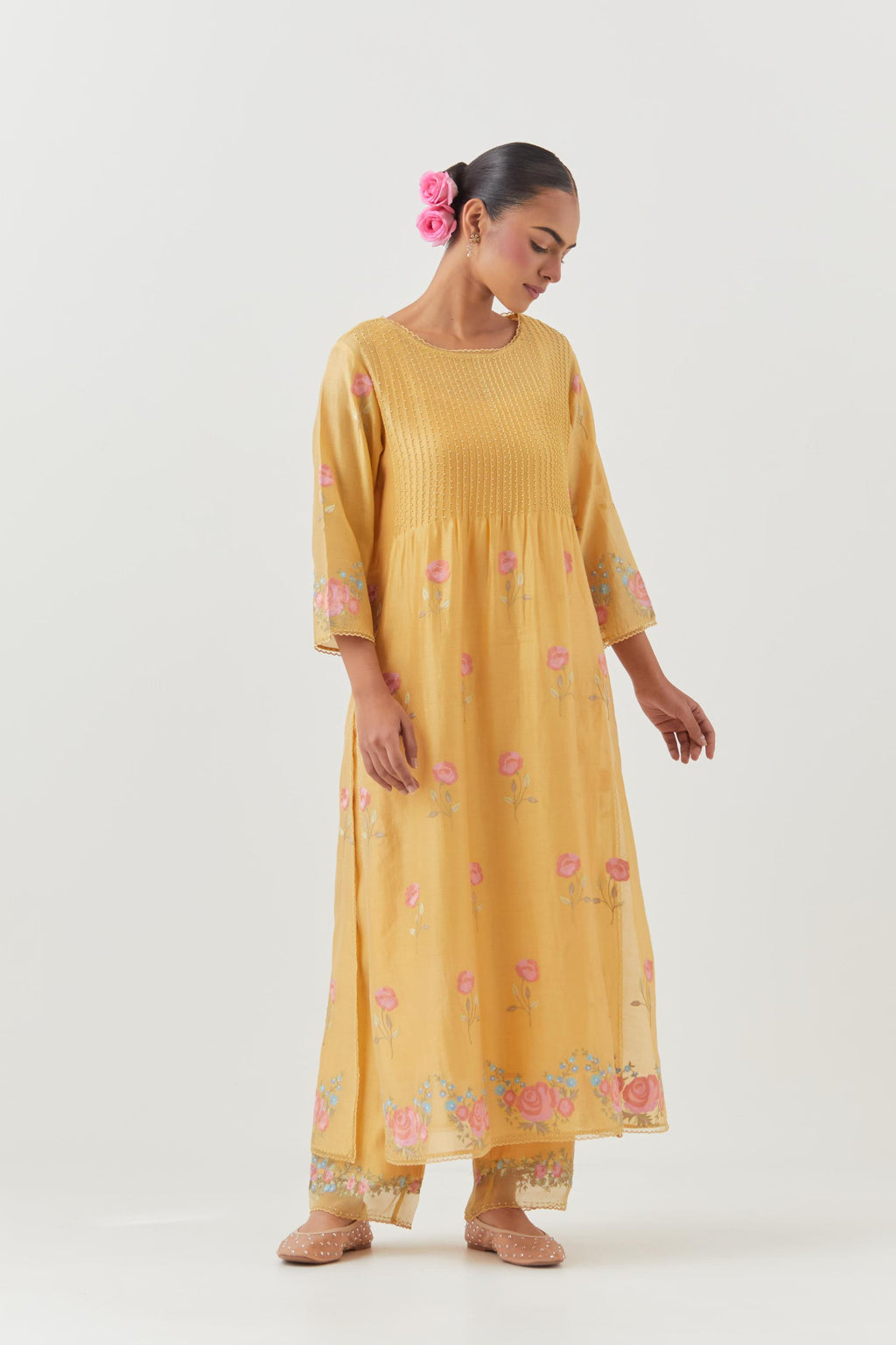 Yellow silk chanderi kurta set with pin tucks at yoke and all-over rose flower embroidery.