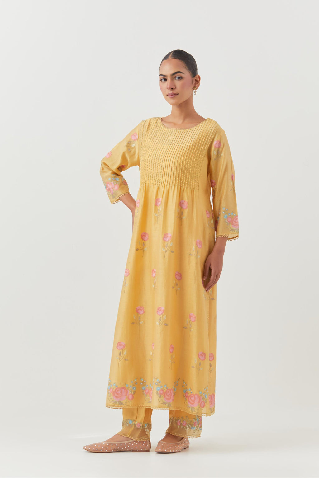 Yellow silk chanderi kurta set with pin tucks at yoke and all-over rose flower embroidery.