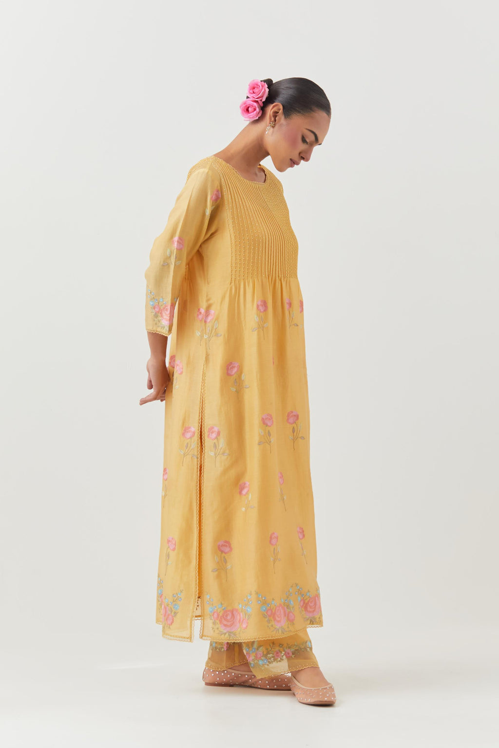 Yellow silk chanderi kurta set with pin tucks at yoke and all-over rose flower embroidery.