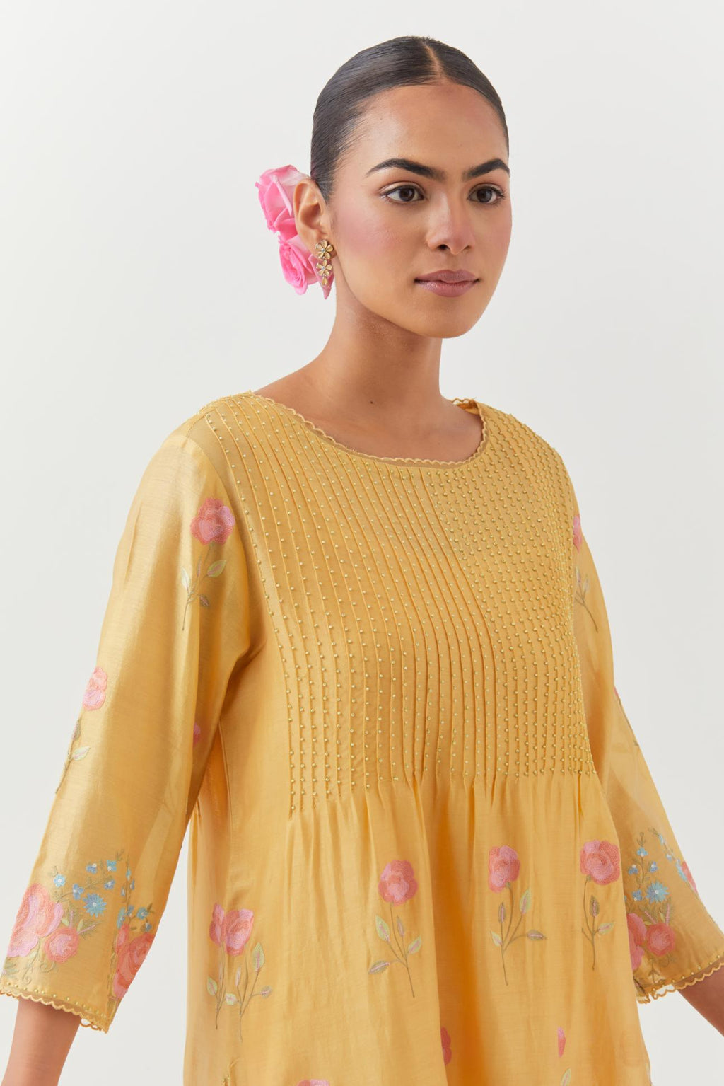 Yellow silk chanderi kurta set with pin tucks at yoke and all-over rose flower embroidery.