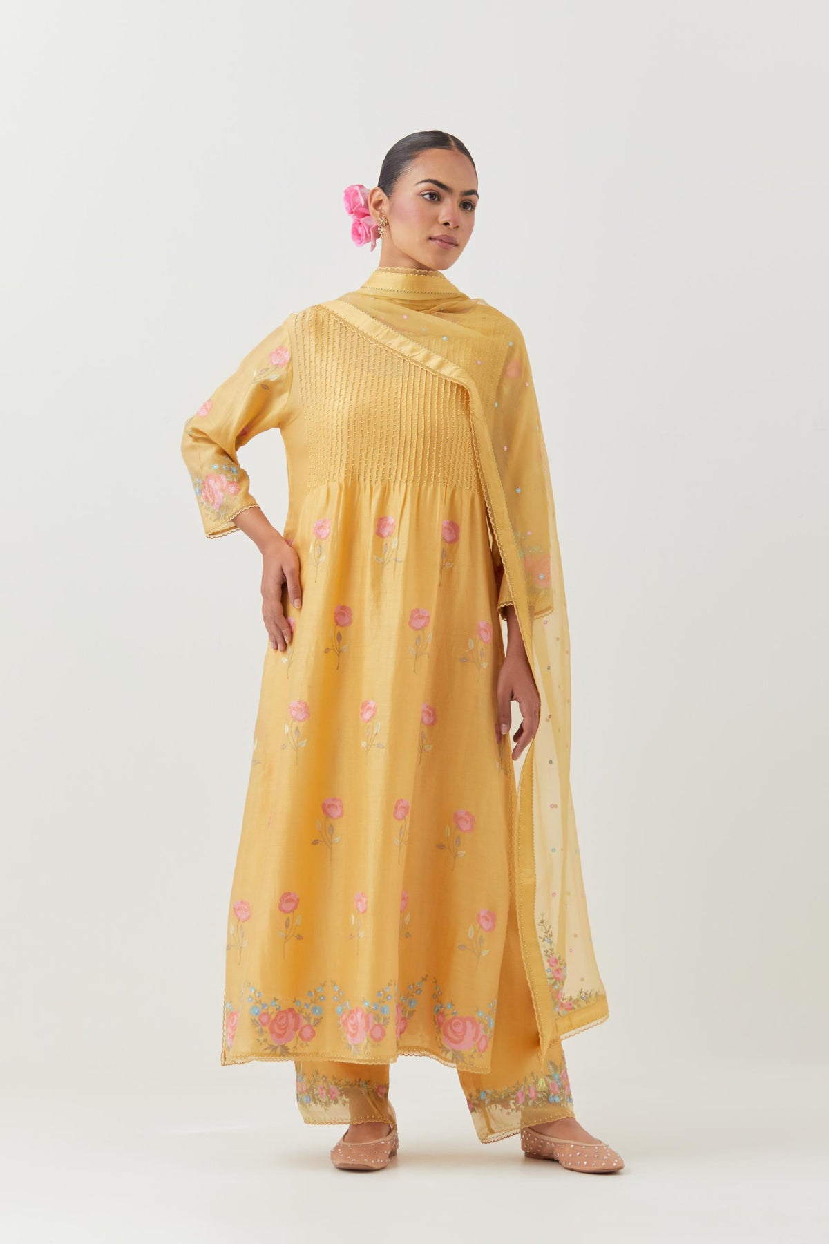 Yellow silk chanderi kurta set with pin tucks at yoke and all-over rose flower embroidery.