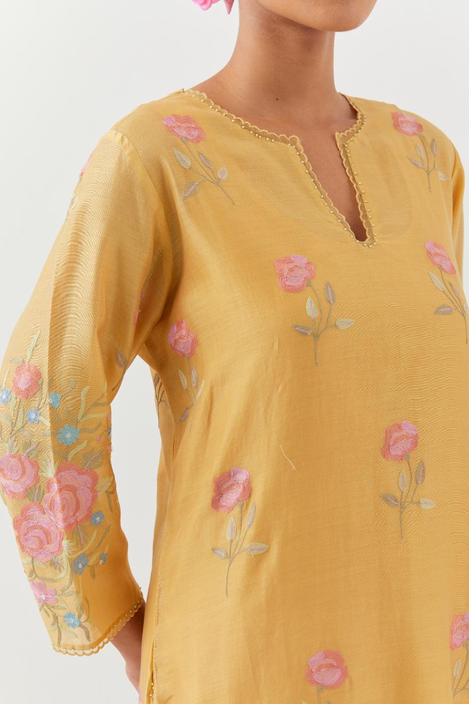 Yellow silk Chanderi straight kurta set with all-over roses embroidered in thread and scalloped organza detail at the edges.