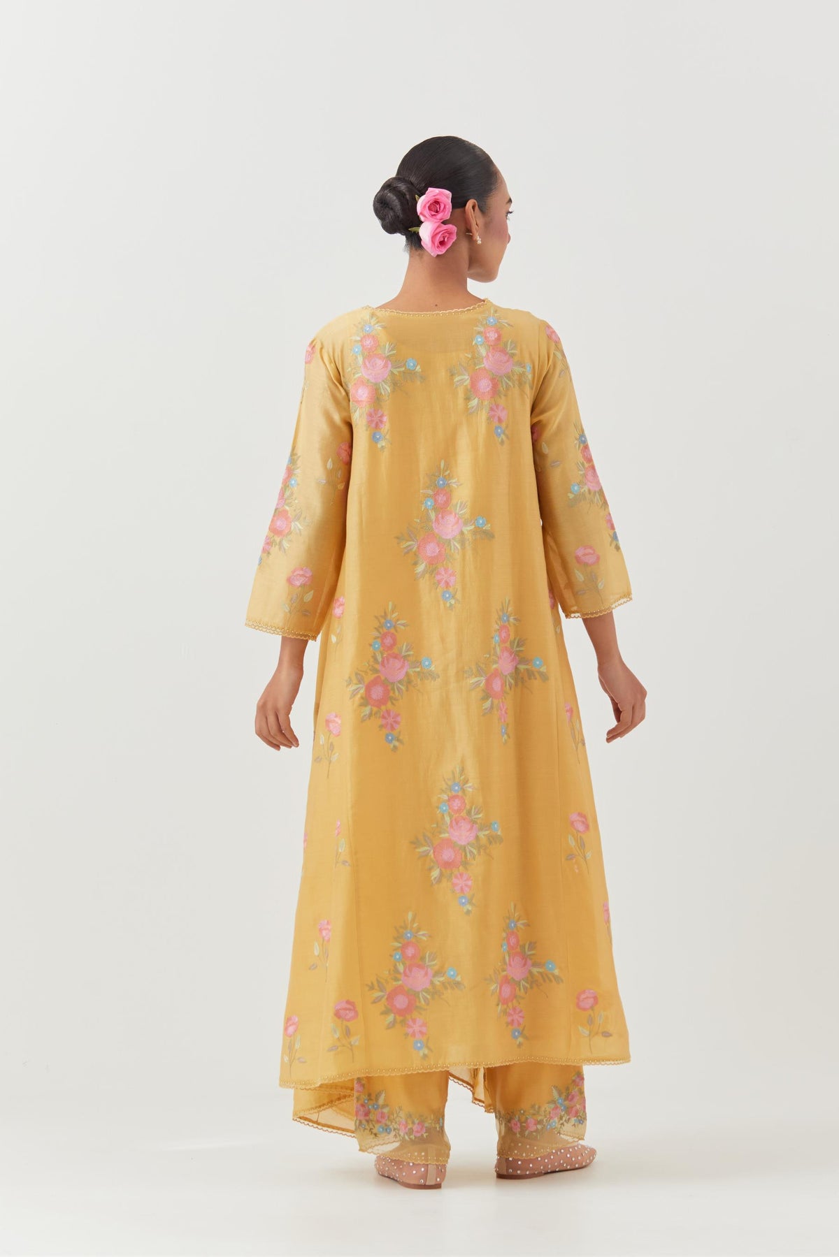 Yellow silk chanderi easy fit, asymmetric hem, paneled kurta set with all-over thread embroidered roses, highlighted with scalloped organza at the edges with contrast beads.