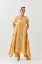 Yellow silk chanderi easy fit, asymmetric hem, paneled kurta set with all-over thread embroidered roses, highlighted with scalloped organza at the edges with contrast beads.