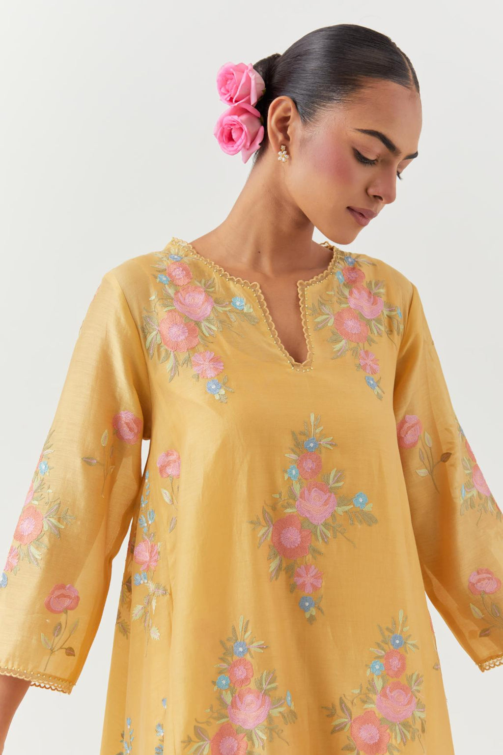 Yellow silk chanderi easy fit, asymmetric hem, paneled kurta set with all-over thread embroidered roses, highlighted with scalloped organza at the edges with contrast beads.