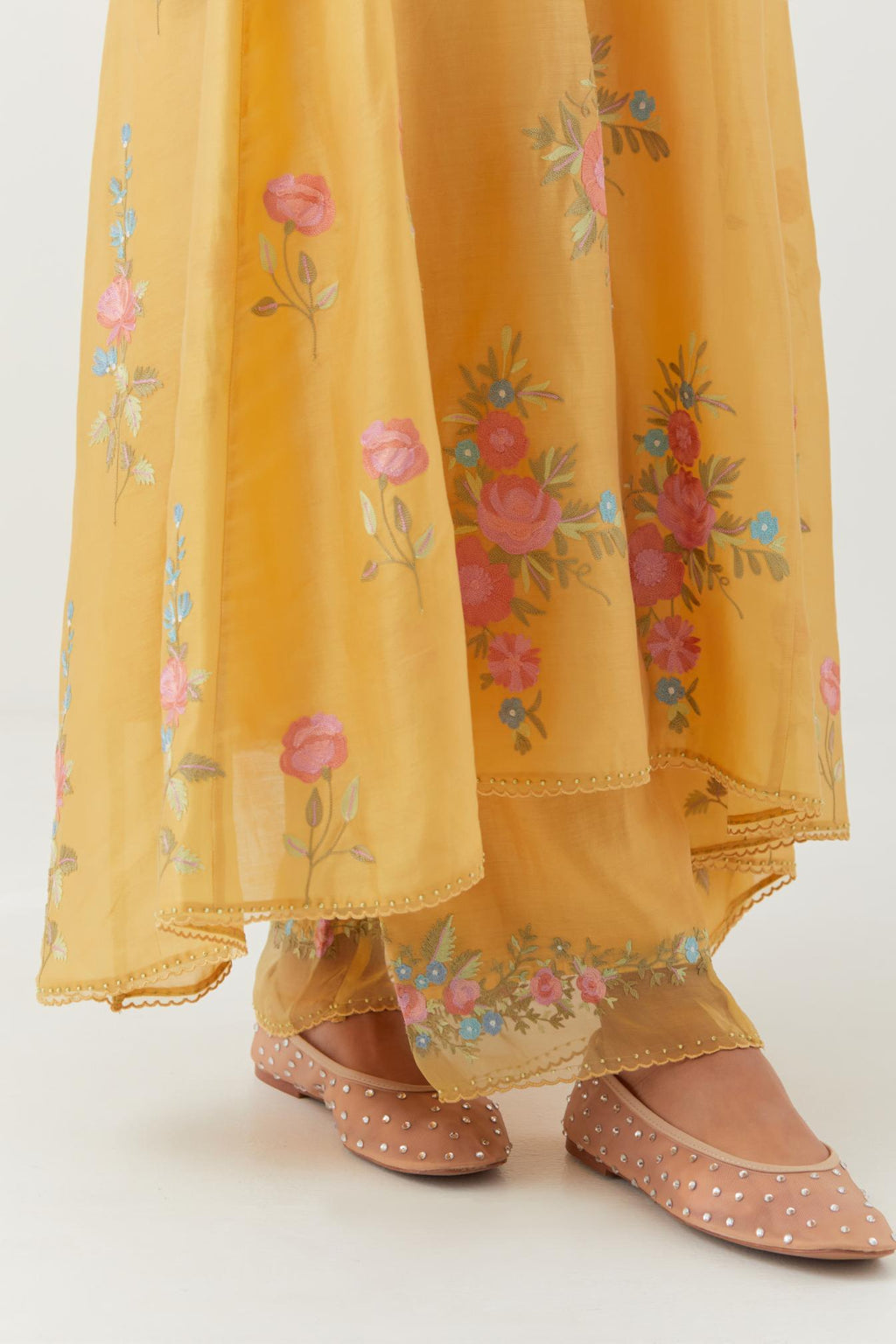 Yellow silk chanderi easy fit, asymmetric hem, paneled kurta set with all-over thread embroidered roses, highlighted with scalloped organza at the edges with contrast beads.