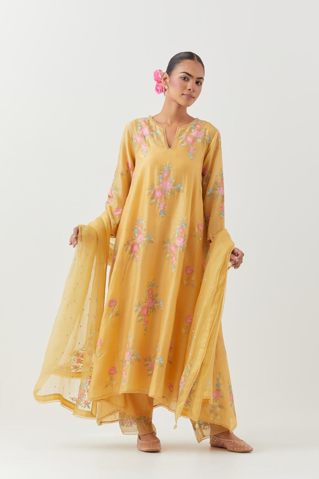 Yellow silk chanderi easy fit, asymmetric hem, paneled kurta set with all-over thread embroidered roses, highlighted with scalloped organza at the edges with contrast beads.