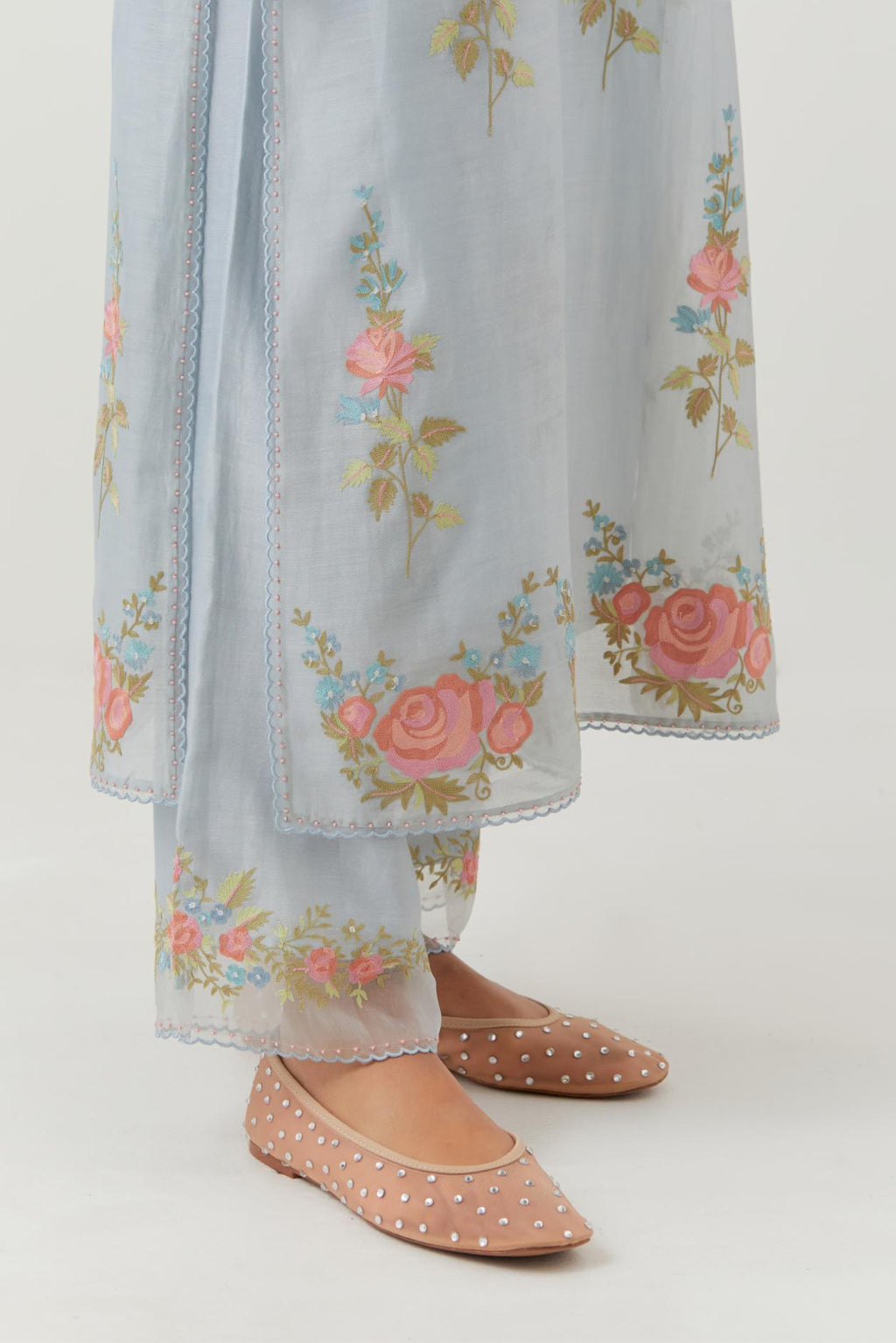 Blue silk Chanderi straight kurta set with all-over rose embroidery and scalloped organza detail at the edges.