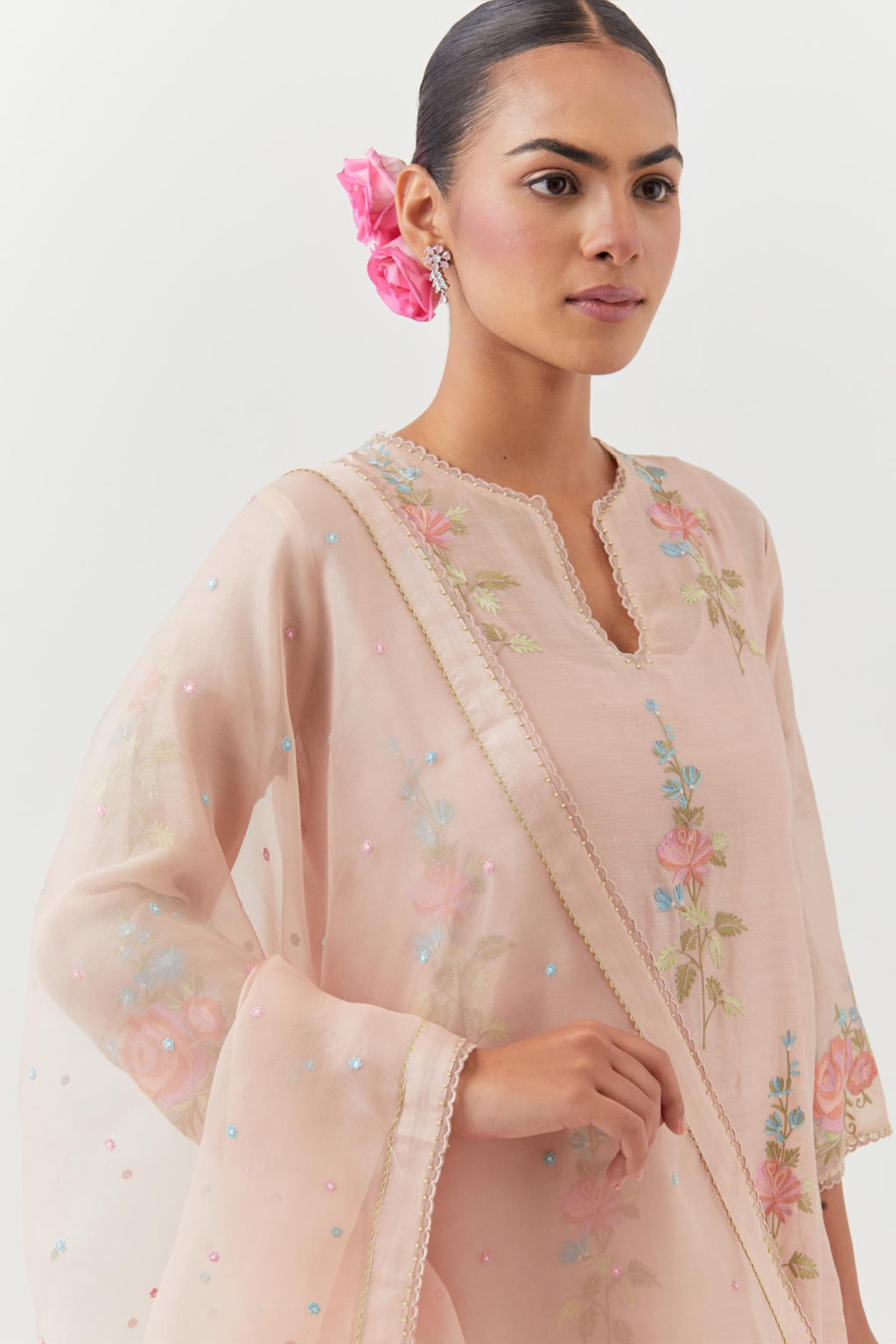 Pink silk Chanderi straight kurta set with all-over rose embroidery and scalloped organza detail at the edges.